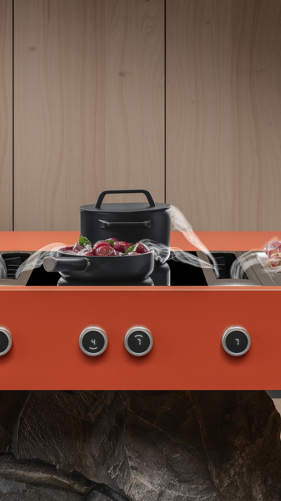 Moderner BORA Kochfeldabzug mit Umluftfunktion, rotes Kochfeld mit Töpfen und Pfanne, nachhaltig kochen ohne Dunstfahne.