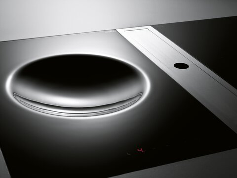 BORA Kochfeld mit integriertem Dunstabzug und digitaler Steuerung, modernes Design in Schwarz und Edelstahl.