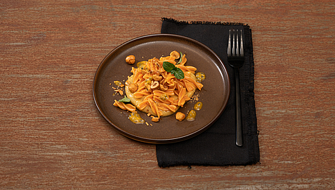 Lentil pasta with lentil cream, passion fruit and hazelnuts