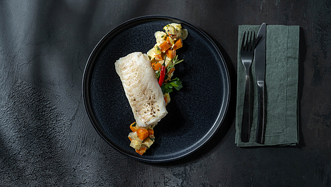 Sous-vide cod on a bed of creamy root vegetables 
