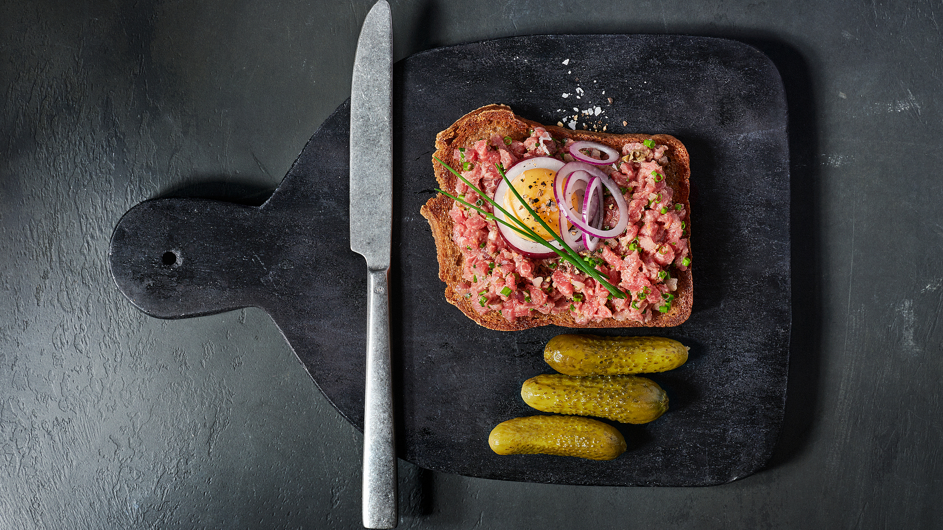 Toast with beef tartare and poached egg yolk