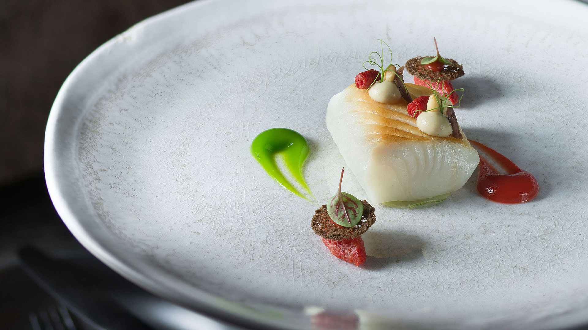 Halibut with olive chips, tomato and basil