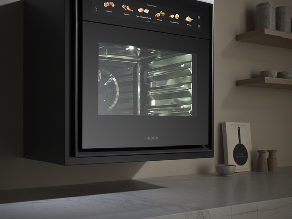 BORA Combi-Dampfgarer in moderner Küchenumgebung mit Touch-Display und Edelstahl-Design. BORA Combi-Dampfgarer in moderner Küchenumgebung mit Touch-Display und Edelstahl-Design.