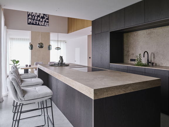 Moderne BORA Küche mit Kochinsel, Induktionskochfeld und integriertem Abluftsystem, kombiniert mit dunklem Holz und hellem Stein. Moderne BORA Küche mit Kochinsel, Induktionskochfeld und integriertem Abluftsystem, kombiniert mit dunklem Holz und hellem Stein.